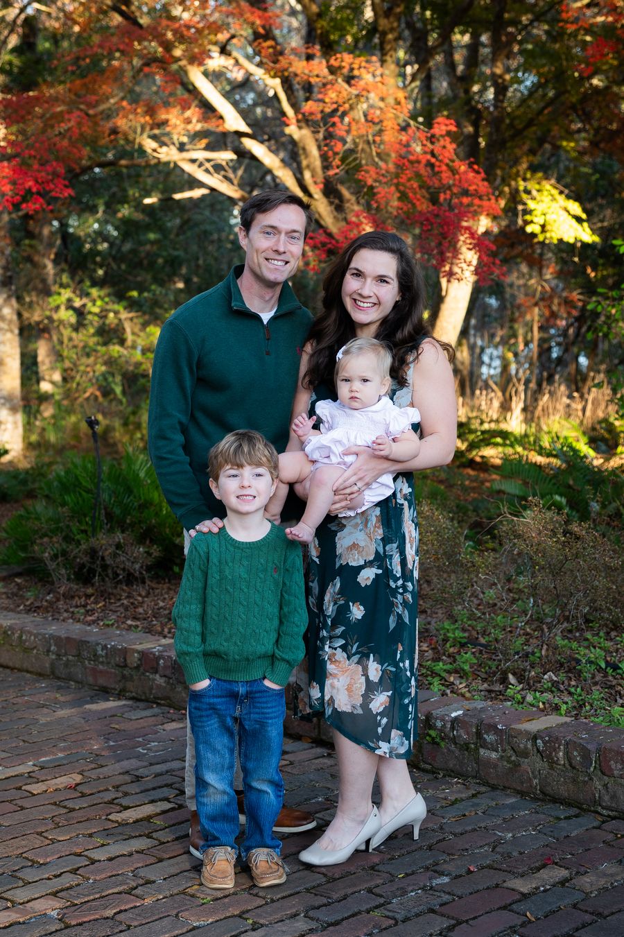 Austin Mall with his wife and two young children in front of autumn maples